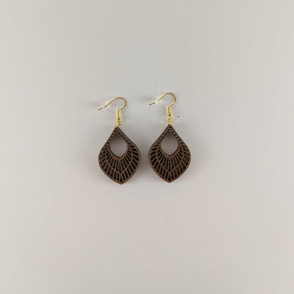 Handcrafted teak earrings featuring intricate laser-engraved designs, showcasing natural wood grain and artistic detailing. They feature a beautiful petal design.