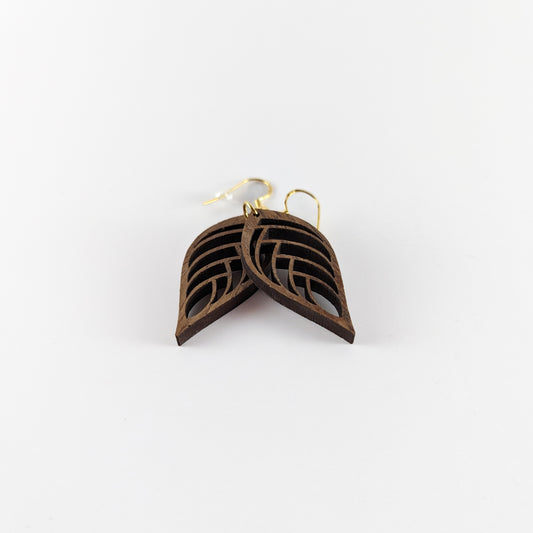 Handcrafted teak earrings featuring intricate laser-engraved designs, showcasing natural wood grain and artistic detailing. They feature a beautiful leaf design.